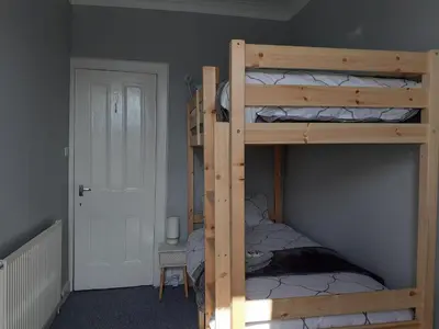 a bedroom with two bunk beds in a room at Castleview is a lovely flat in a listed building in Rothesay