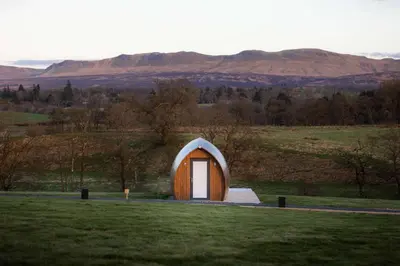 a small dome house with a door in a field at Endrick Escape - Luxury Glamping in Gartness