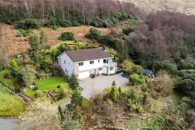 an aerial view of a white house on a hill at Braemor 4 bedroom villa, all en-suite in Arrochar