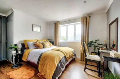 a bedroom with a bed and a window at Braemor 4 bedroom villa, all en-suite in Arrochar