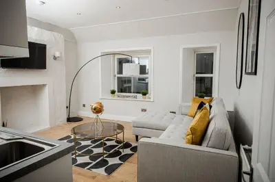 a living room with a couch and a table at 2 BDR House At Caledonia Luxe Stays Short Lets & Serviced Accommodation Crieff in Crieff