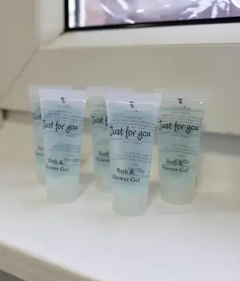 four containers of just for cream sitting on a shelf at Raploch House in Larkhall