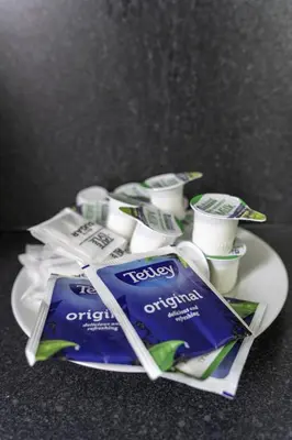 a plate with toothbrushes and cups of toothpaste at Raploch House in Larkhall