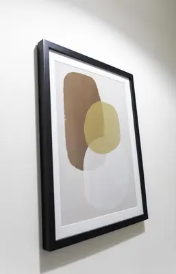 a framed picture of a brown and yellow painting on a wall at Raploch House in Larkhall