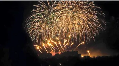 a fireworks display with a city in the background at Amazing Castle View Apartment in Edinburgh