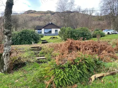 a house in the middle of a field at the waterside - carrick castle - loch goil in Carrick