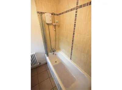 a bathroom with a tub and a shower at 1 Planetree Cottage - Loch View in Lochgoilhead