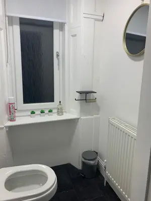 a white bathroom with a toilet and a window at Glasgow, Bothwell, 3 bed, Suitable for Long Stays in Bothwell