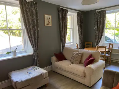 a living room with a couch and a table at Fabulous 2 Bedroom House just outside Edinburgh in Auchendinny
