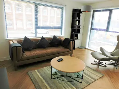 a living room with a couch and a table at Brand new gorgeous 2 bed Apt in Finnieston in Glasgow