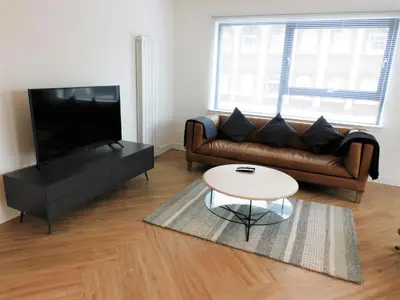 a living room with a couch and a coffee table at Brand new gorgeous 2 bed Apt in Finnieston in Glasgow