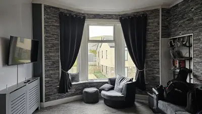 a living room with a couch and a window at Moorburn Heights in Largs