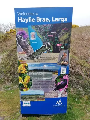 a sign on the side of a field with birds on it at Moorburn Heights in Largs