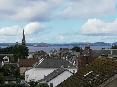 a view of a city with a church and the water at Moorburn Heights in Largs