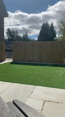 a backyard with a wooden fence and a bench at Laburnam Villa - Luxury 4 bedroom accommodation in the heart of Killin in Killin