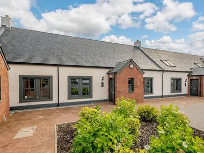 an exterior view of a house with a driveway at Westertonhill Newbuild Lodges with Private Hot Tub Hire Available in Balloch