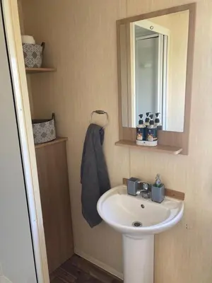 a bathroom with a sink and a mirror at 367 Caravan in Stevenston
