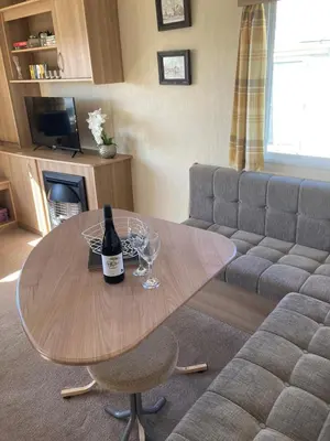a table with two glasses and a bottle of wine at 367 Caravan in Stevenston