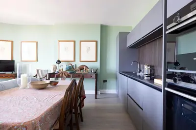 a kitchen and dining room with a table and chairs at JOIVY Inviting Flat at the Heart of Edinburgh in Edinburgh