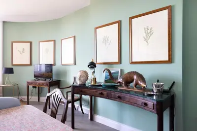 a room with a wooden desk with a television at JOIVY Inviting Flat at the Heart of Edinburgh in Edinburgh