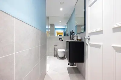 a bathroom with a toilet and a sink at JOIVY Inviting Flat at the Heart of Edinburgh in Edinburgh