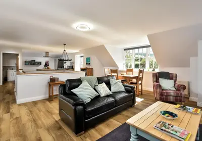 a living room with a couch and a table at The Studio at Pitmeadow Farm in Dunning
