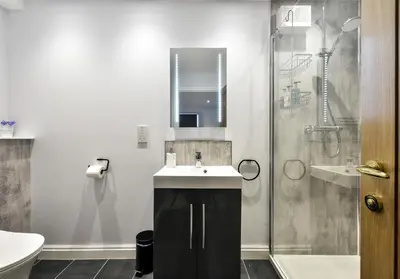 a bathroom with a sink and a shower at The Studio at Pitmeadow Farm in Dunning