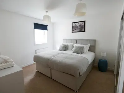 a bedroom with a large white bed with two pillows at Beautiful Unique 3Bed Mews Cottage House - Pass the Keys in Glasgow