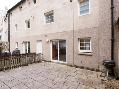 a patio in front of a brick building at Beautiful Unique 3Bed Mews Cottage House - Pass the Keys in Glasgow