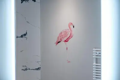 a pink flamingo is standing on a wall at Unique Two Bed Holiday Home in Edinburgh in Edinburgh