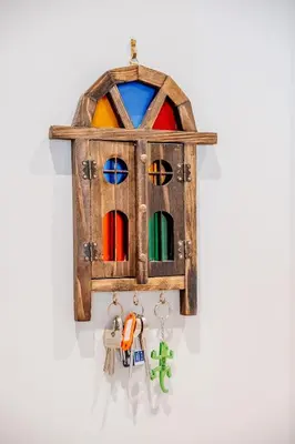 a wooden birdhouse hanging on a wall with keys at Unique Two Bed Holiday Home in Edinburgh in Edinburgh