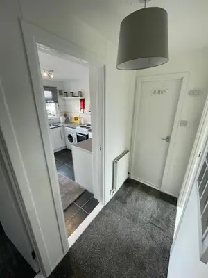 a hallway with a door leading to a kitchen at 1-Bedroom Chalet at Maryville Caravan Site - Uddingston, Glasgow in Uddingston