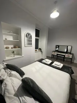 a bedroom with a large white bed with two pillows at One bedroom flat in Oban town centre in Oban