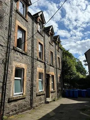 an old brick building with windows on the side at One bedroom flat in Oban town centre in Oban