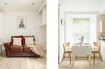 a living room with a couch and a table at Central Studio Near Usher Hall & Edinburgh Castle in Edinburgh
