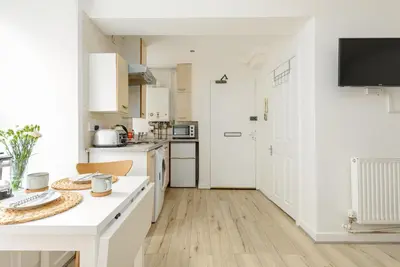 a kitchen with white cabinets and a white counter top at Central Studio Near Usher Hall & Edinburgh Castle in Edinburgh