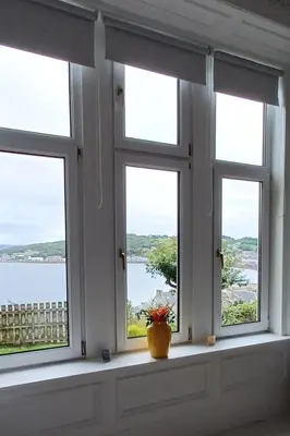 a window with a vase sitting on a window sill at Dairsie Sea View in Rothesay