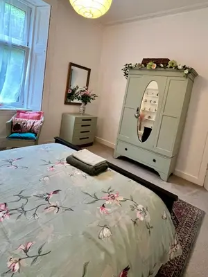 a bedroom with a bed and a washing machine at Dairsie Sea View in Rothesay