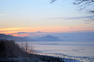 a view of the ocean at sunset at Chapelton Cottage in Strachur