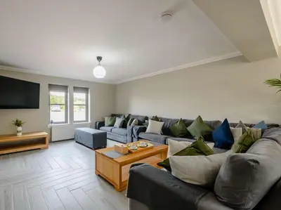 a living room with a couch and a tv at Westertonhill Lodge - 4 Bedrooms Sleeps 10 with Private Hot Tub Hire Available in Balloch