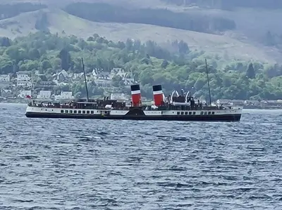 a large boat in a large body of water at Superb Loch Side Apartment with Sea & Sunset Views in Helensburgh