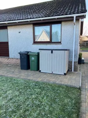 a house with two trash cans in front of it at Charming 2 bed house Perfect base for sightseeing in Johnstone