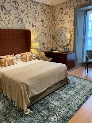 a bedroom with a large bed with a rug at The Raeburn in Edinburgh