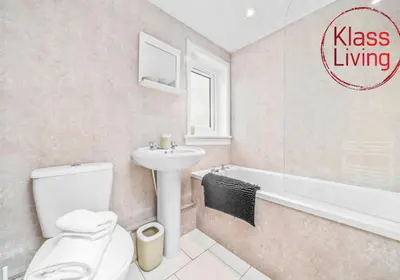 a bathroom with a toilet and a sink and a bath tub at West End House by Klass Living Bellshill in Bellshill