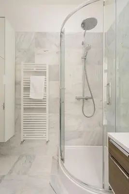 a bathroom with a shower with a glass door at Heriot Bridge Hideaway by Calton Living in Edinburgh