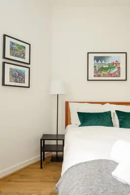 a white bedroom with a bed and a table at Heriot Bridge Hideaway by Calton Living in Edinburgh