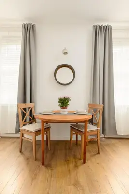 a dining room table with two chairs and a mirror at Heriot Bridge Hideaway by Calton Living in Edinburgh