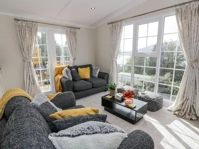 a living room with two couches and a table at 11 Mansion View in Helensburgh