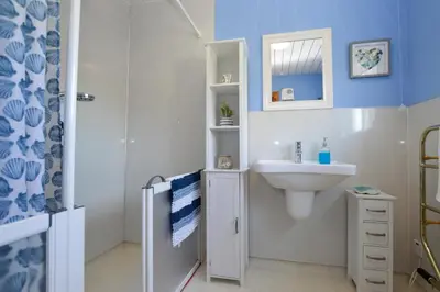 a bathroom with a sink and a toilet and a mirror at Bay View in Lochgilphead
