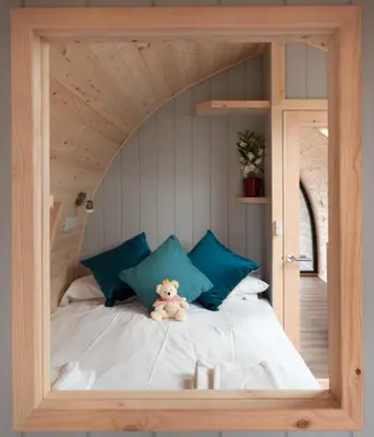 a teddy bear sitting on a bed in a room at Callander Hostel in Callander